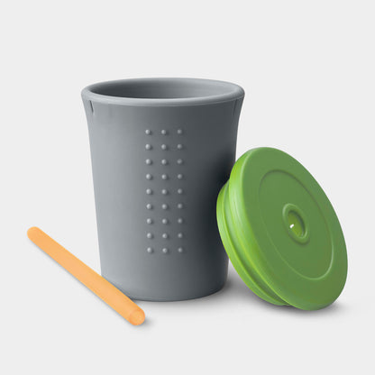 Child holding a GoSili reusable silicone cup with a soft straw for easy sipping.
