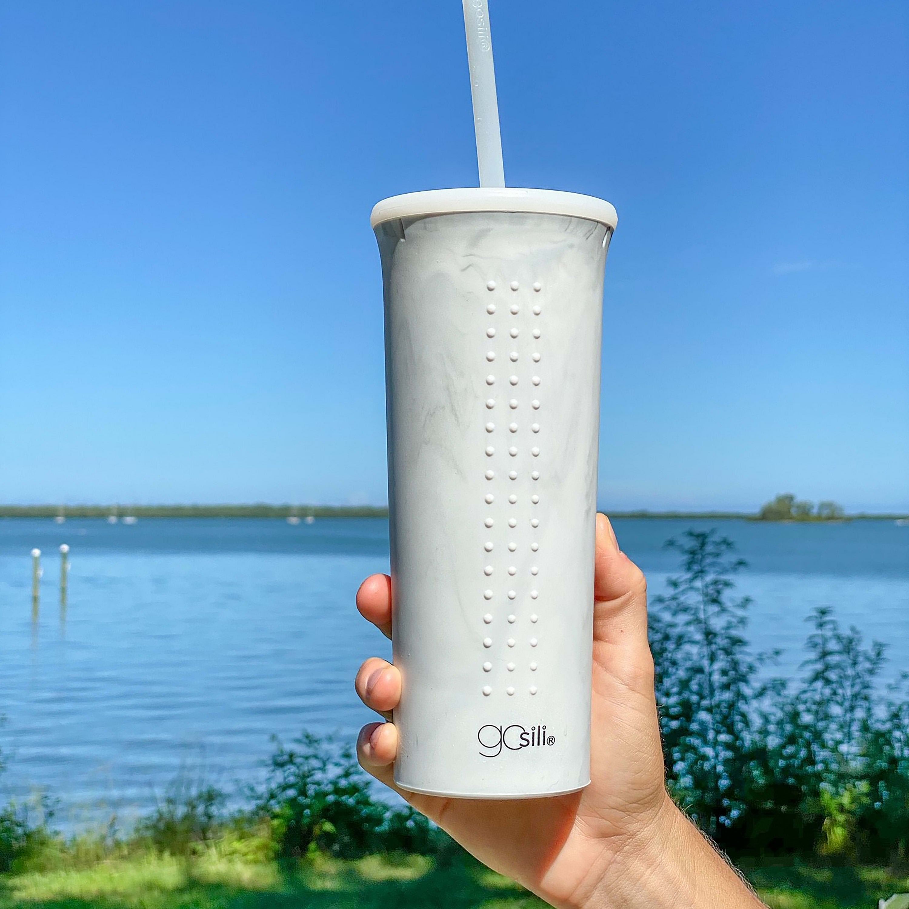 Soft, non-toxic silicone cup with a translucent reusable straw.